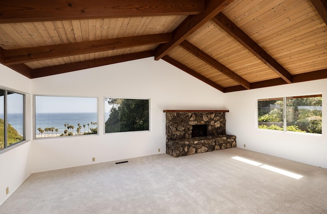 unfurnished living room with beamed ceiling, a water view, and wood ceiling