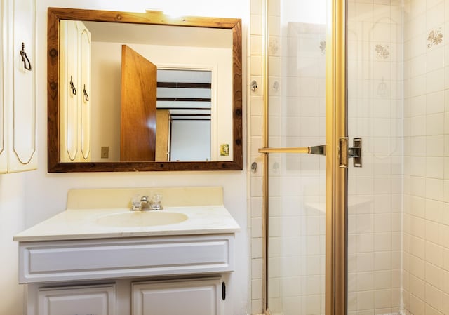 bathroom featuring vanity and an enclosed shower