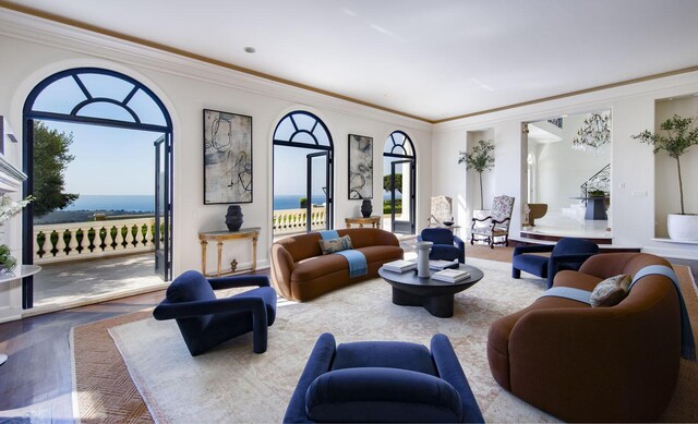 living room with ornamental molding and a water view