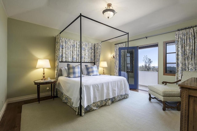 bedroom featuring hardwood / wood-style flooring and access to exterior