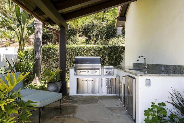 view of patio / terrace with a grill, area for grilling, and sink