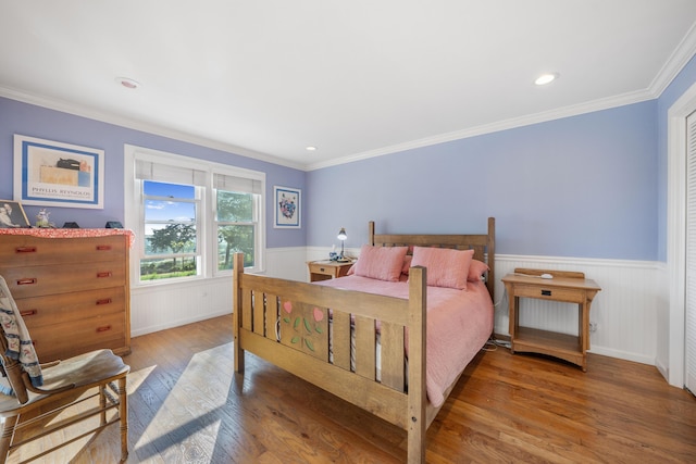 bedroom with crown molding and wood-type flooring