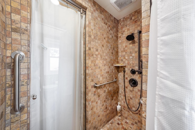 bathroom with a tile shower