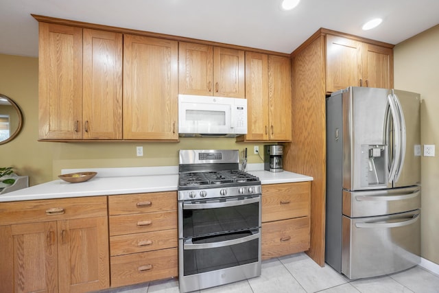 kitchen featuring stainless steel appliances and light tile patterned floors