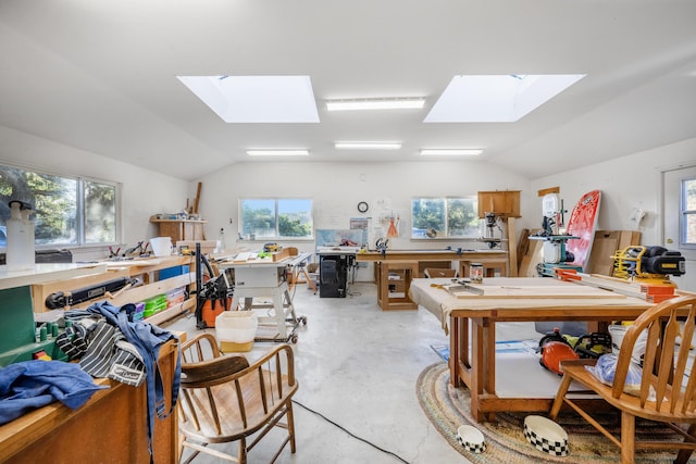 miscellaneous room featuring a workshop area and vaulted ceiling