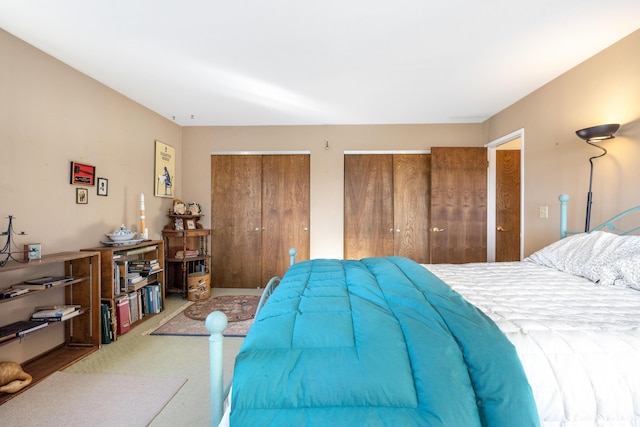 carpeted bedroom with multiple closets