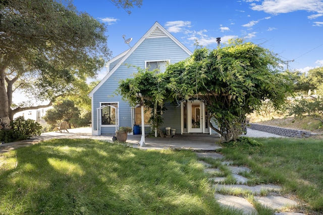 rear view of property with a patio and a yard