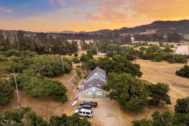 aerial view at dusk featuring a mountain view