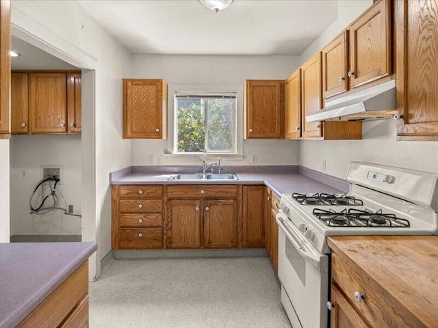 kitchen featuring white gas stove and sink