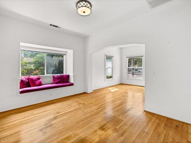 unfurnished room featuring visible vents and wood finished floors