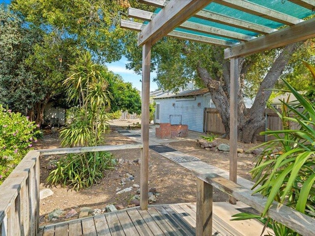 wooden terrace with fence and a pergola