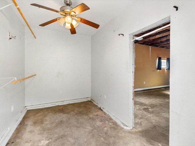 spare room featuring a ceiling fan and unfinished concrete floors