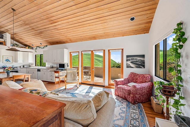 living room featuring light hardwood / wood-style floors, wooden ceiling, and a healthy amount of sunlight