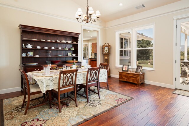 dining space with a notable chandelier and dark wood-type flooring