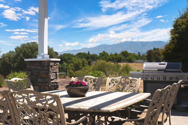 view of patio / terrace with a mountain view and grilling area