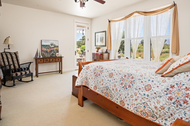 bedroom featuring light carpet, access to outside, and ceiling fan