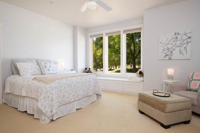 bedroom with light colored carpet and ceiling fan