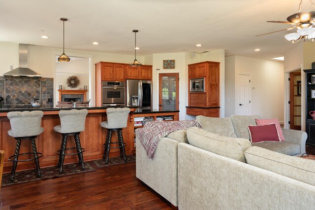 living room featuring dark hardwood / wood-style floors and ceiling fan