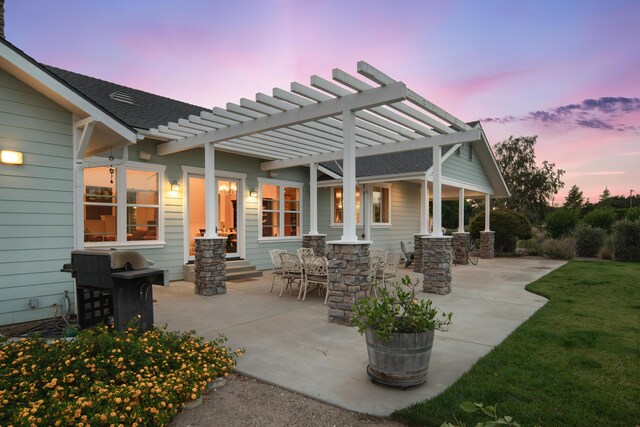 patio terrace at dusk with a yard and a pergola