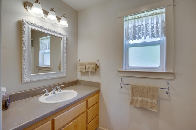 bathroom featuring plenty of natural light and vanity