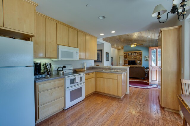 kitchen with light brown cabinets, white appliances, and light wood-type flooring