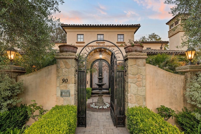 view of gate at dusk