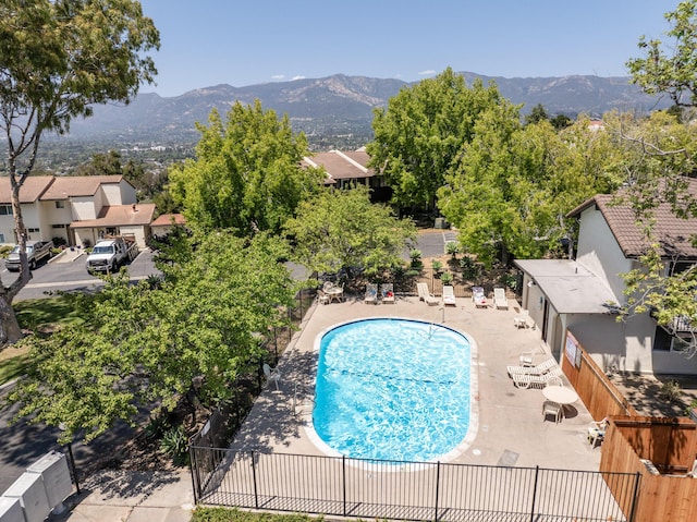 view of swimming pool featuring a mountain view and a patio area