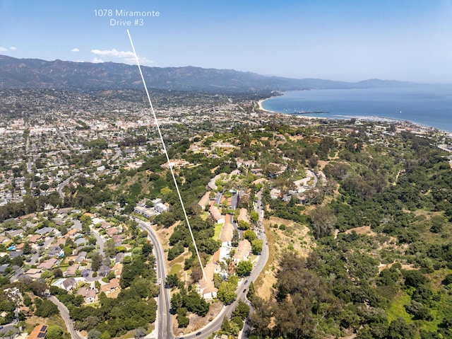 drone / aerial view featuring a water and mountain view