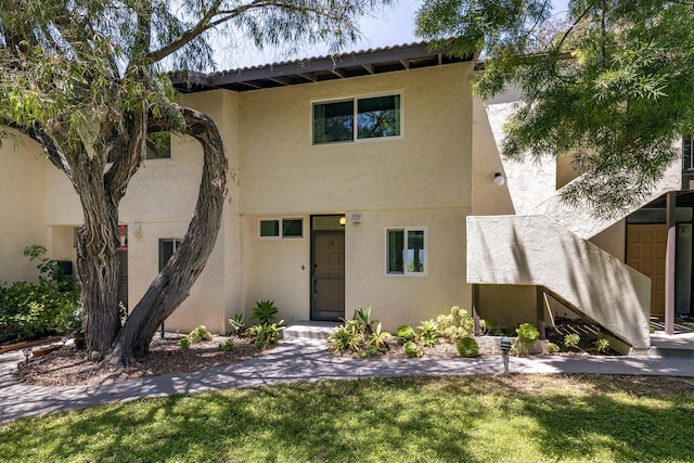 mediterranean / spanish-style home featuring a front yard