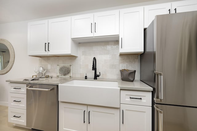 kitchen with white cabinetry, stainless steel appliances, and sink