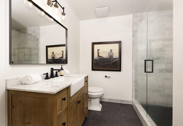 bathroom featuring vanity, toilet, tile patterned floors, and a shower with shower door