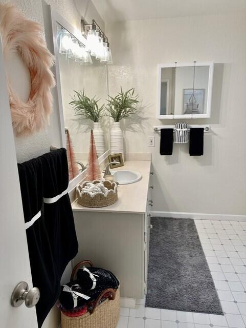 bathroom featuring vanity and baseboards