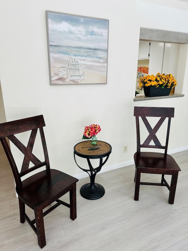 sitting room with light wood-style flooring and baseboards