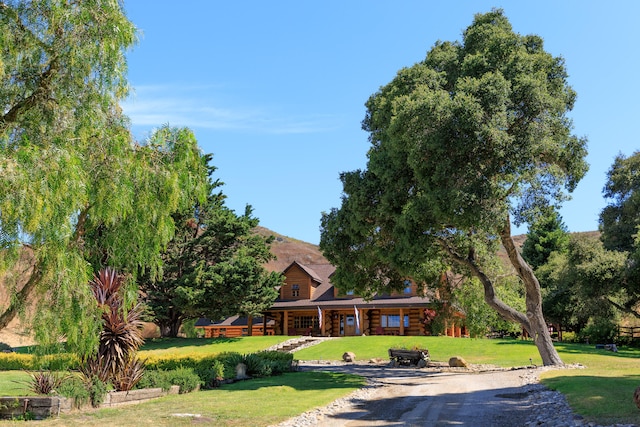 log home featuring a front lawn