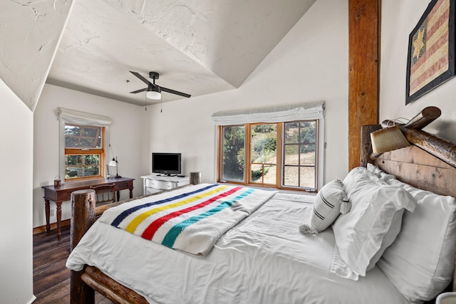 bedroom featuring dark hardwood / wood-style floors, vaulted ceiling, and ceiling fan