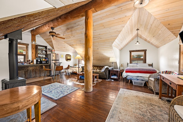 bedroom with vaulted ceiling with beams, a wood stove, wood ceiling, and dark wood-type flooring