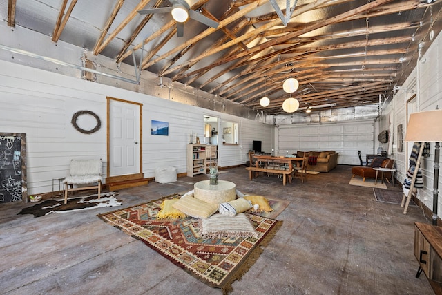 living room featuring concrete flooring and lofted ceiling
