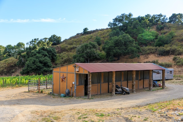 view of stable featuring an outbuilding and a rural view