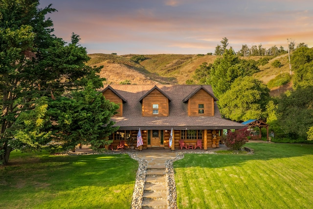 log home featuring a lawn and a mountain view