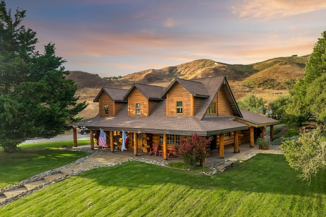 log-style house featuring a yard and a mountain view