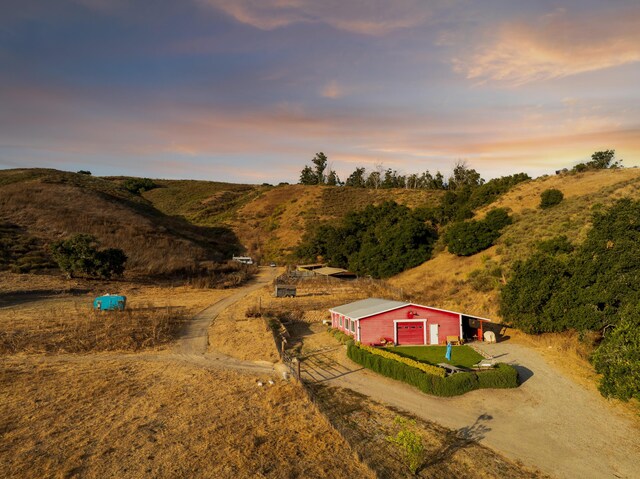 aerial view at dusk featuring a rural view