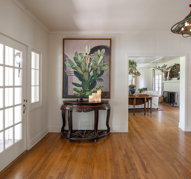 1259 Alamo Pintado Rd, Solvang, CA 93463 - entryway featuring ornamental molding, wood finished floors, a decorative wall, a fireplace, and baseboards