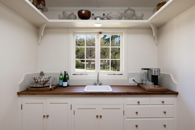 1259 Alamo Pintado Rd, Solvang, CA 93463 - kitchen with wood counters, a sink, and white cabinetry