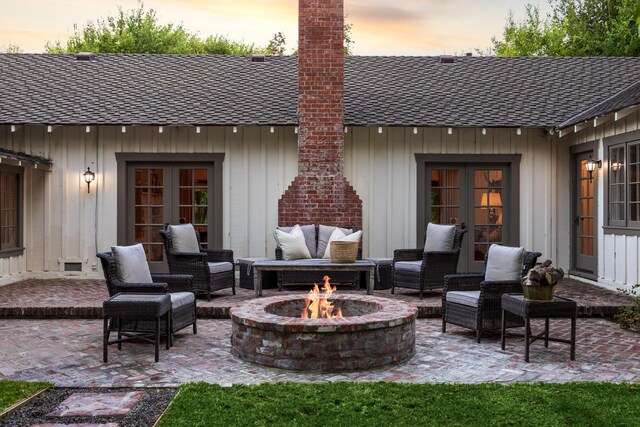1259 Alamo Pintado Rd, Solvang, CA 93463 - patio terrace at dusk with french doors, a patio area, and an outdoor living space with a fire pit