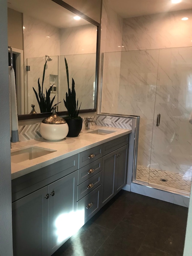 bathroom with vanity, a shower with shower door, and tile patterned floors