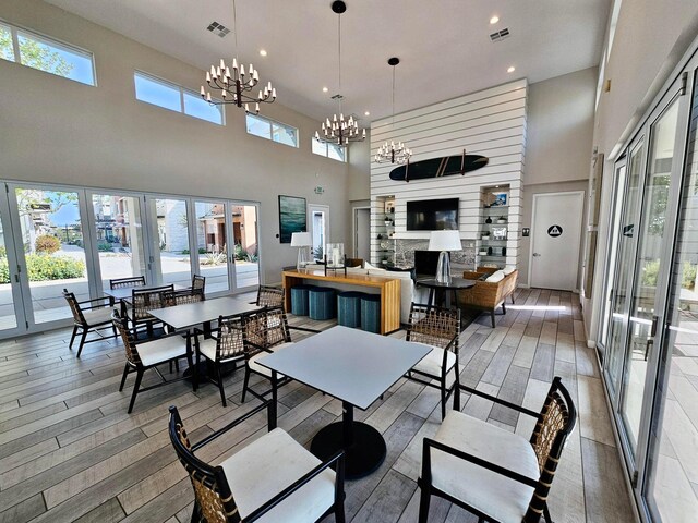 dining space with plenty of natural light, an inviting chandelier, and hardwood / wood-style floors