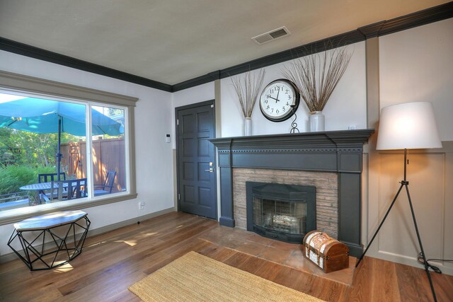 unfurnished living room with crown molding and wood-type flooring