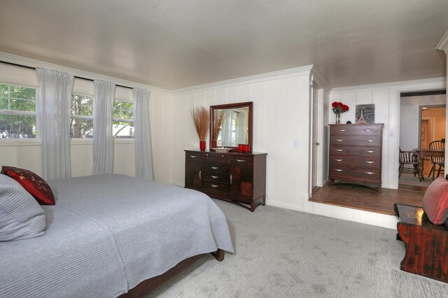 bedroom featuring ornamental molding and hardwood / wood-style flooring