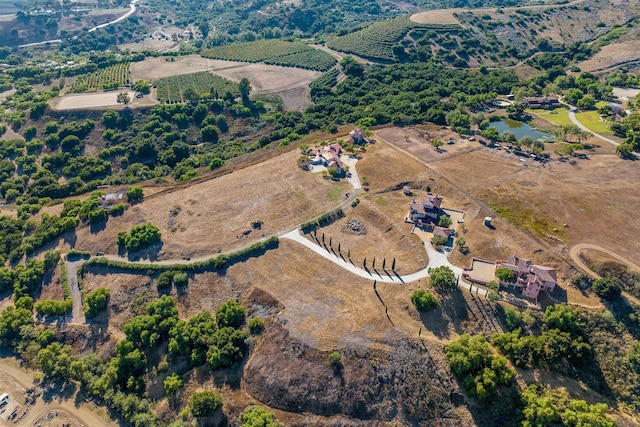 birds eye view of property with a rural view