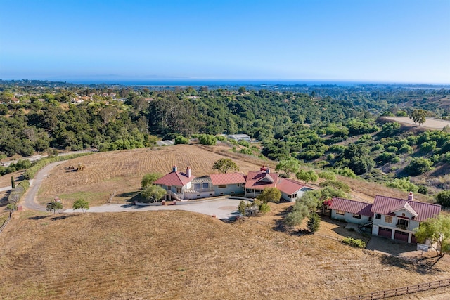 birds eye view of property with a forest view